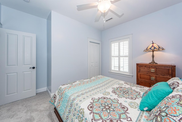 bedroom featuring ceiling fan, light colored carpet, and a closet