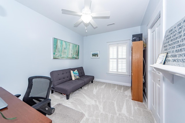 office area featuring light carpet and ceiling fan