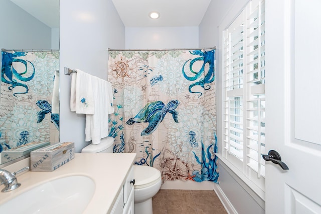 full bathroom featuring tile patterned flooring, vanity, a healthy amount of sunlight, and toilet