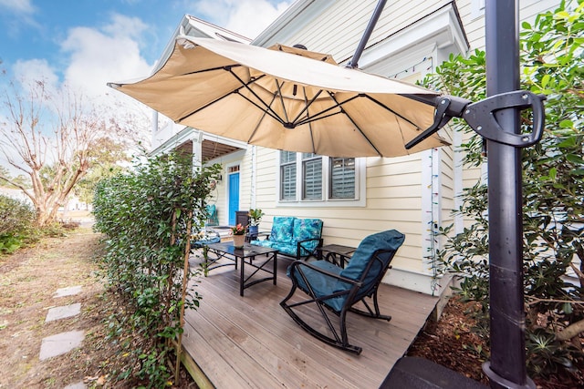 wooden deck with an outdoor living space