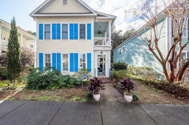 view of front of property with a balcony and ceiling fan