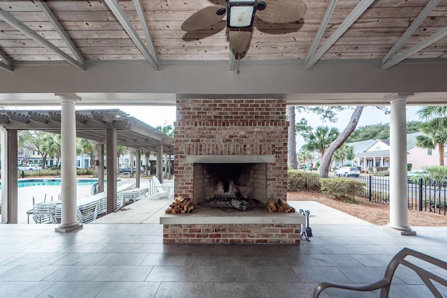 view of patio with a fenced in pool, an outdoor brick fireplace, and ceiling fan