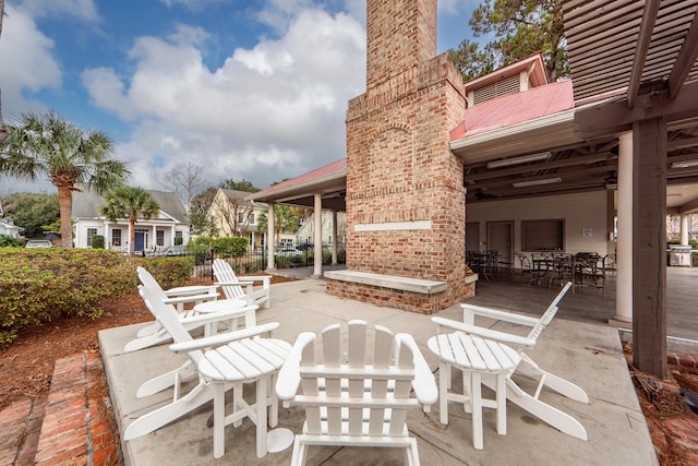 view of patio with an outdoor brick fireplace