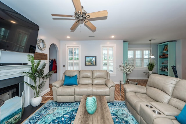 living room featuring hardwood / wood-style floors and ceiling fan