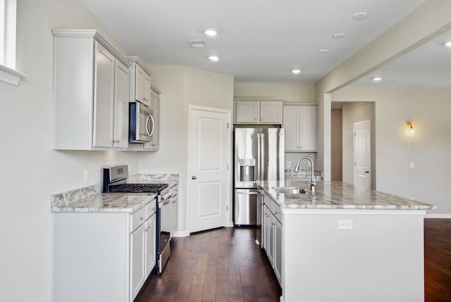 104 Wild Orchid Way, Huger, SC 29450 - kitchen with stainless steel appliances, light stone countertops, dark wood-type flooring, a center island with sink, and recessed lighting