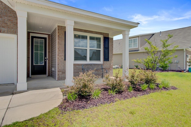 104 Wild Orchid Way, Huger, SC 29450 - doorway to property with brick siding, covered porch, and a yard