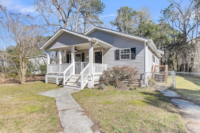 bungalow with covered porch, fence, a ceiling fan, a gate, and a front yard