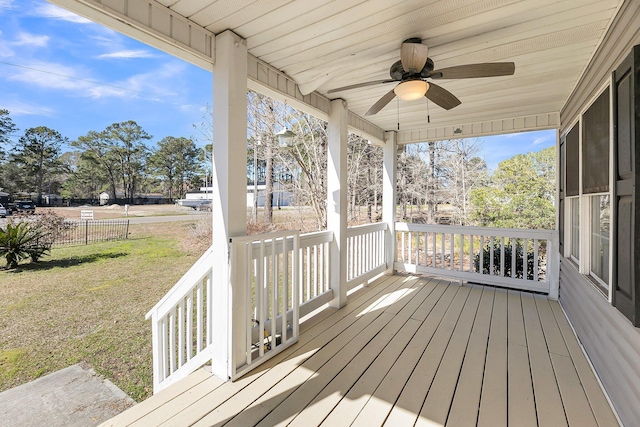 deck featuring fence, a ceiling fan, and a yard