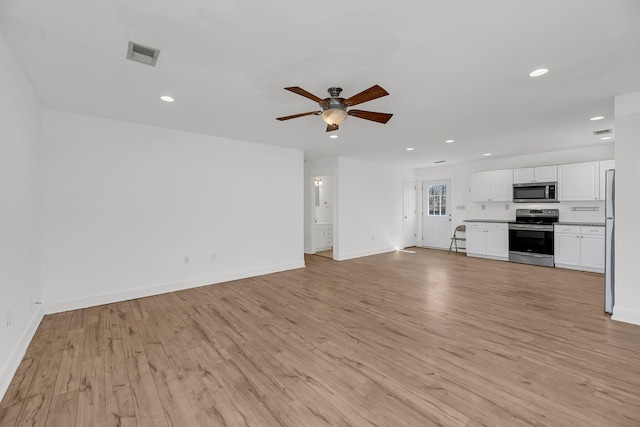 unfurnished living room featuring recessed lighting, visible vents, light wood-style flooring, and baseboards