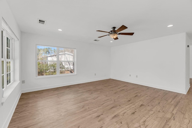 spare room featuring baseboards, visible vents, ceiling fan, light wood-style floors, and recessed lighting