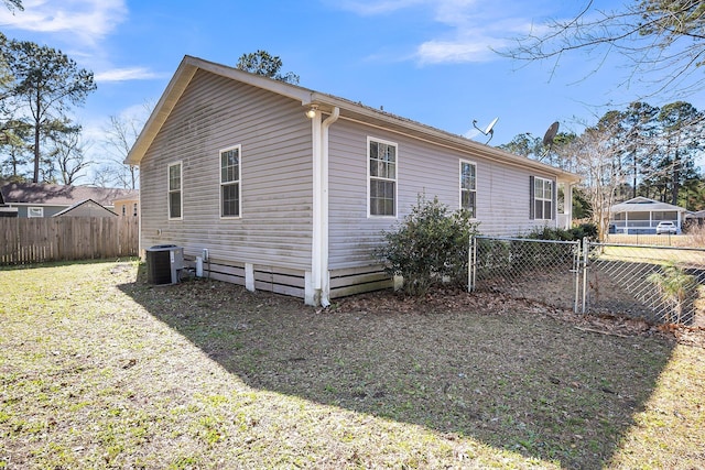 view of home's exterior with fence and central AC