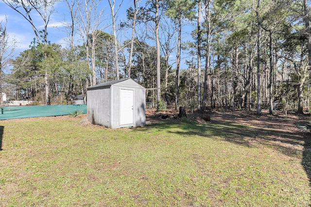 view of yard featuring a shed, fence, and an outdoor structure