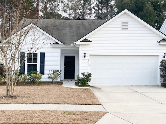 ranch-style house featuring a garage and concrete driveway