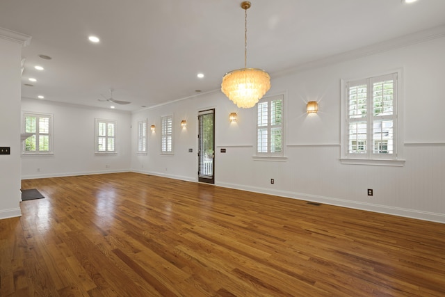 2258 Arthur Gaillard Ln, Charleston, SC 29414 - unfurnished living room with wood finished floors, wainscoting, ornamental molding, plenty of natural light, and a chandelier