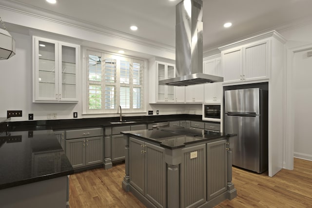 2258 Arthur Gaillard Ln, Charleston, SC 29414 - kitchen with stainless steel appliances, extractor fan, ornamental molding, white cabinetry, and wood finished floors
