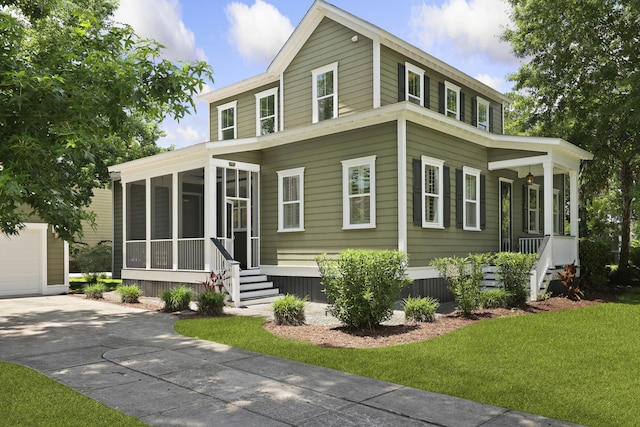2258 Arthur Gaillard Ln, Charleston, SC 29414 - view of front of property with a sunroom, concrete driveway, a garage, a front lawn, and a porch