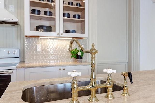 kitchen featuring ventilation hood, white cabinets, light stone counters, white range with electric cooktop, and sink