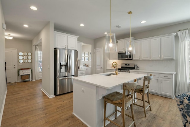 127 Surfbird Rd, Summerville, SC 29486 - kitchen featuring white cabinetry, appliances with stainless steel finishes, light wood-style flooring, and a sink