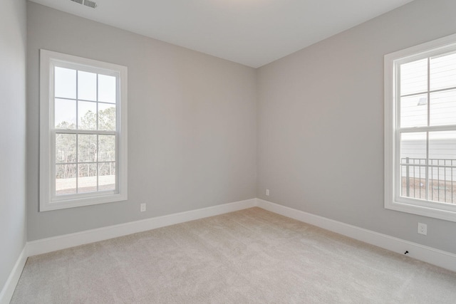 spare room with light colored carpet