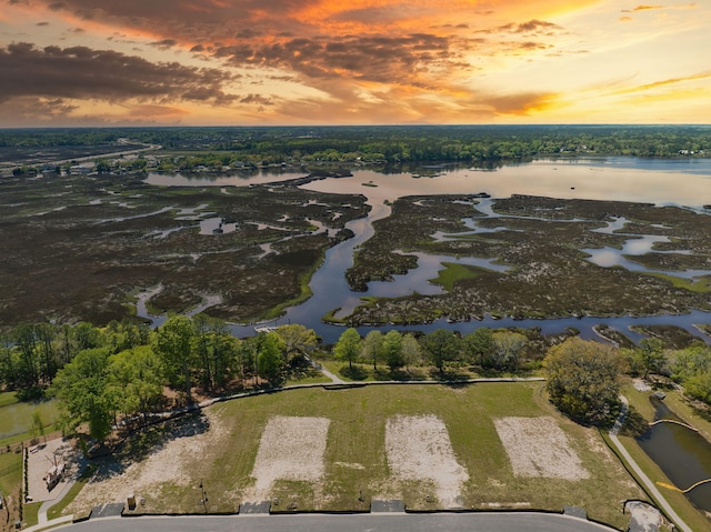 aerial view at dusk with a water view