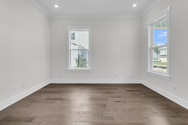 spare room with crown molding and dark hardwood / wood-style floors