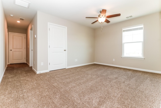 carpeted empty room with ceiling fan