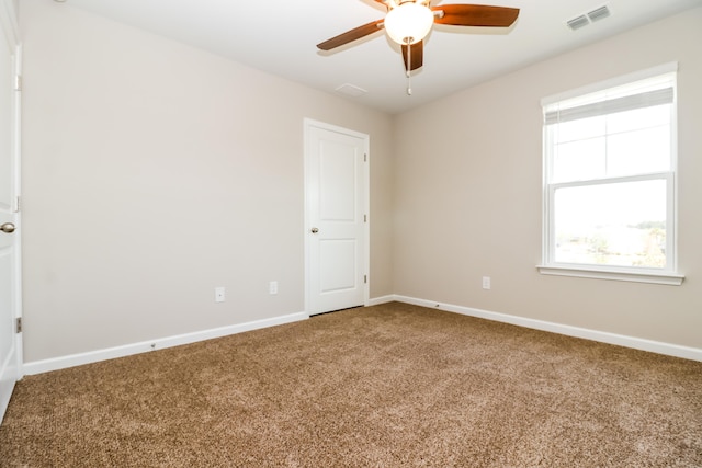 carpeted empty room featuring ceiling fan