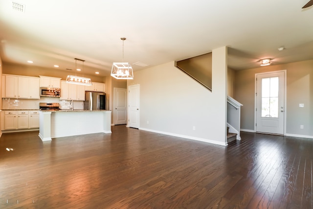 unfurnished living room with dark wood-type flooring