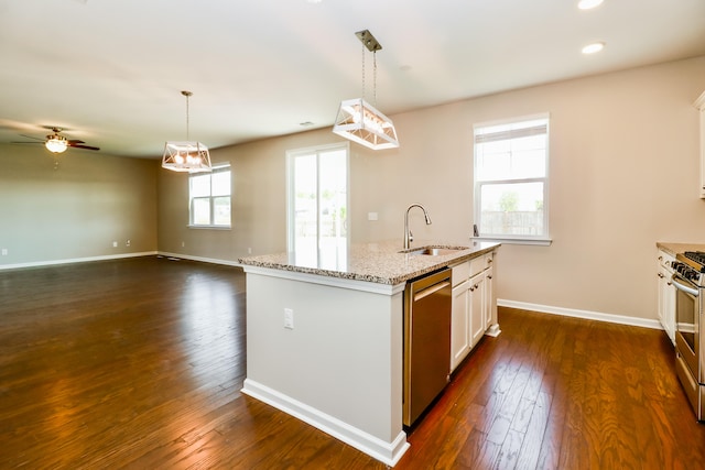 kitchen featuring a healthy amount of sunlight, appliances with stainless steel finishes, a kitchen island with sink, and sink