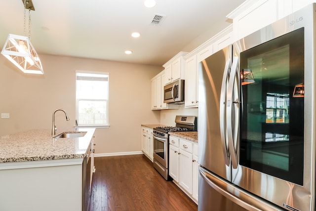 kitchen with white cabinets, stainless steel appliances, dark hardwood / wood-style floors, and sink