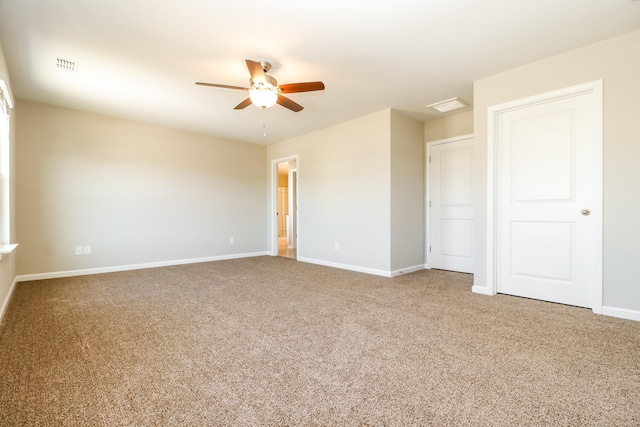 empty room with ceiling fan and light carpet