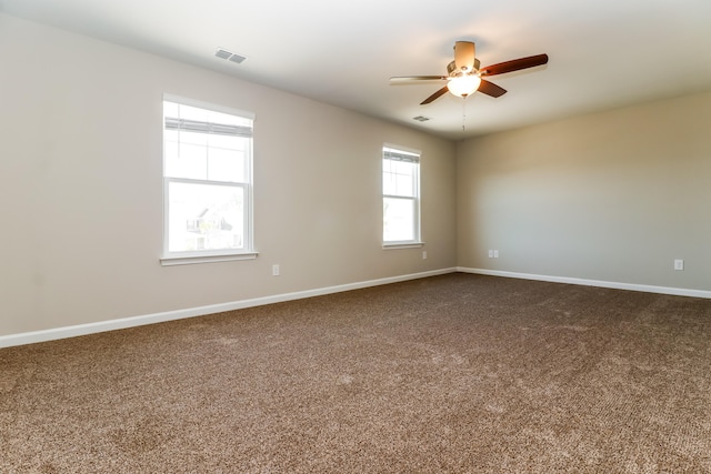 spare room with ceiling fan and carpet floors