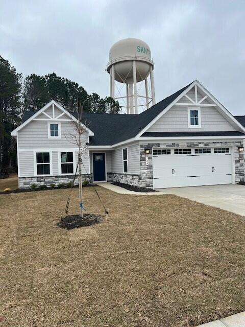 view of front of home featuring a garage and a front lawn