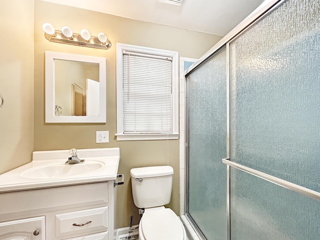bathroom with an enclosed shower, toilet, and vanity