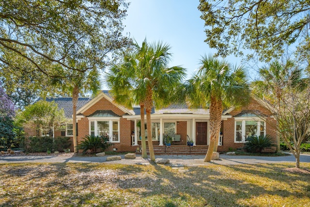 ranch-style home with brick siding and a front lawn