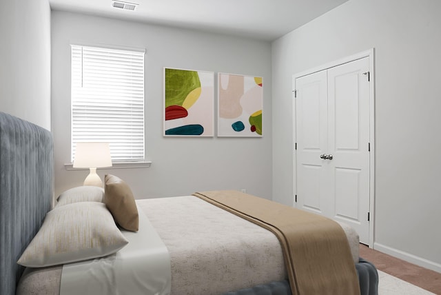 bedroom with visible vents, baseboards, and carpet floors