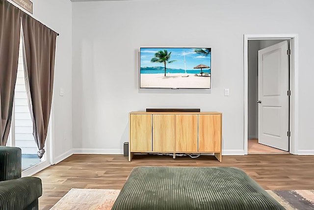 living area with wood finished floors and baseboards