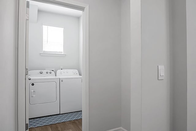 laundry area featuring dark wood-style floors, laundry area, and washer and clothes dryer