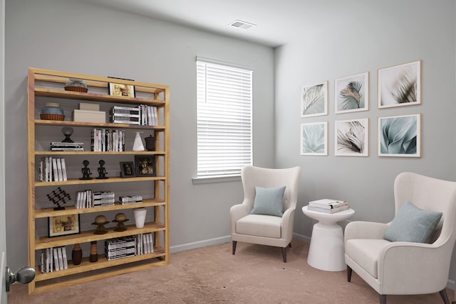 sitting room featuring baseboards, visible vents, and carpet floors