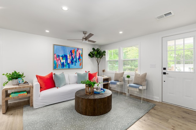 living area featuring recessed lighting, ceiling fan, visible vents, baseboards, and wood finished floors