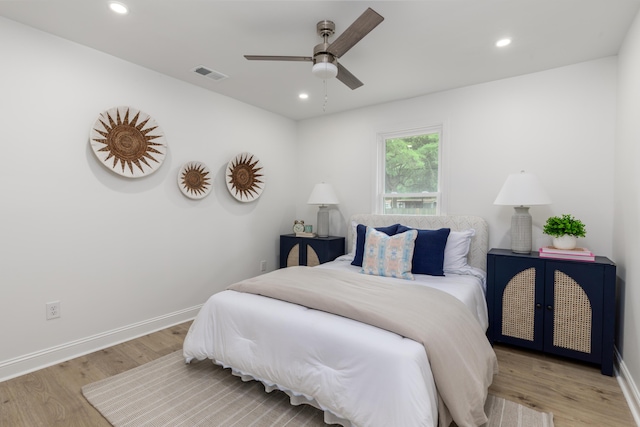 bedroom featuring wood finished floors, visible vents, and recessed lighting