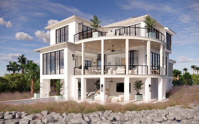 rear view of property with a patio area, ceiling fan, and a balcony