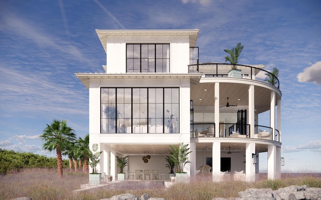 rear view of property featuring a patio, a balcony, and ceiling fan