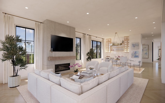 living room featuring recessed lighting and a tile fireplace