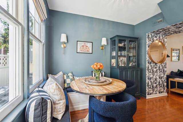 dining room featuring dark hardwood / wood-style flooring, plenty of natural light, and breakfast area