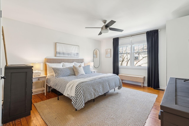 bedroom with ceiling fan and hardwood / wood-style floors