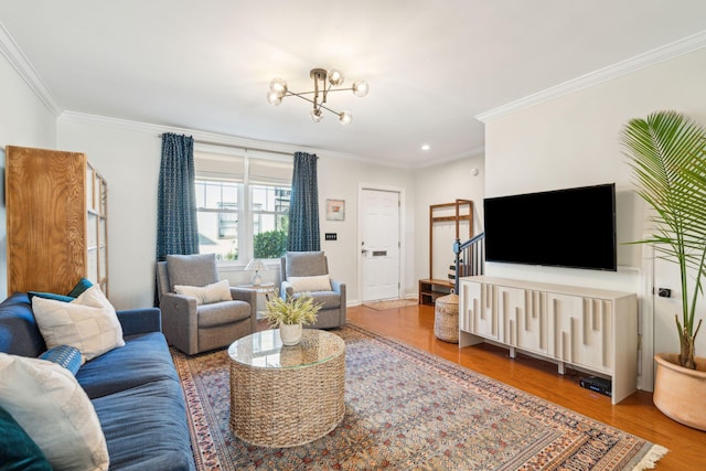 living room with hardwood / wood-style flooring, ornamental molding, and a chandelier