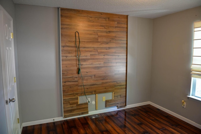 7947 Vermont Rd, North Charleston, SC 29418 - unfurnished bedroom featuring dark wood-type flooring, baseboards, and a textured ceiling