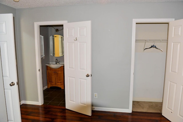 7947 Vermont Rd, North Charleston, SC 29418 - unfurnished bedroom with a sink, dark wood finished floors, baseboards, and ensuite bath