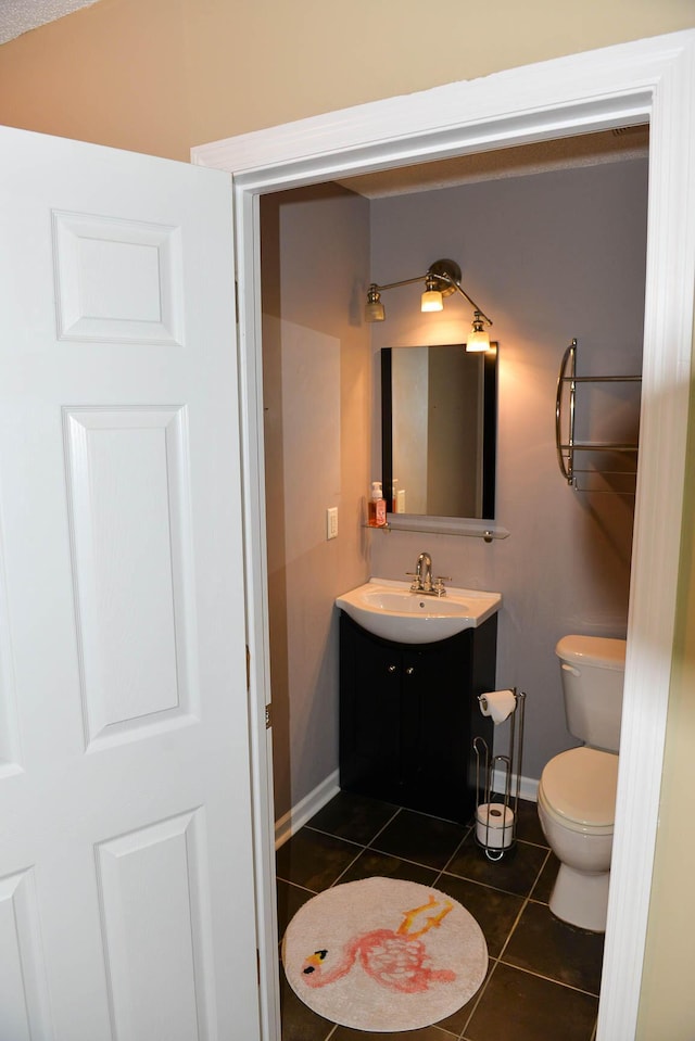 7947 Vermont Rd, North Charleston, SC 29418 - half bath featuring tile patterned floors, vanity, toilet, and baseboards